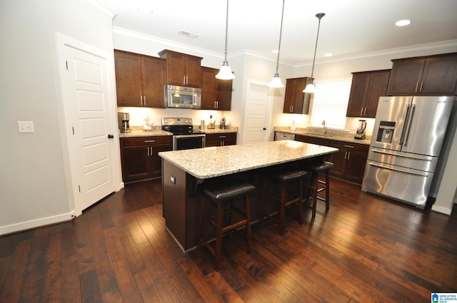 298 Appleford Rd, Helena, AL 35080 - kitchen featuring stainless steel appliances, a breakfast bar, a kitchen island, light stone countertops, and dark brown cabinetry