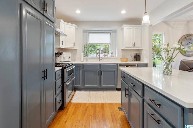 2616 Chimney Hills Cir, Vestavia Hills, AL 35226 - kitchen with stainless steel appliances, a sink, gray cabinets, white cabinets, and recessed lighting