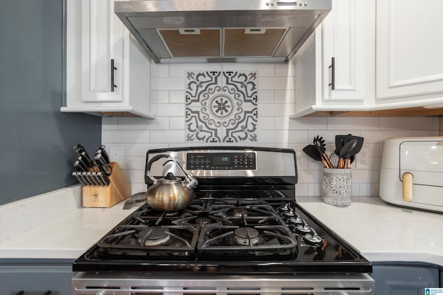 2616 Chimney Hills Cir, Vestavia Hills, AL 35226 - kitchen featuring stainless steel gas range, under cabinet range hood, white cabinets, and decorative backsplash