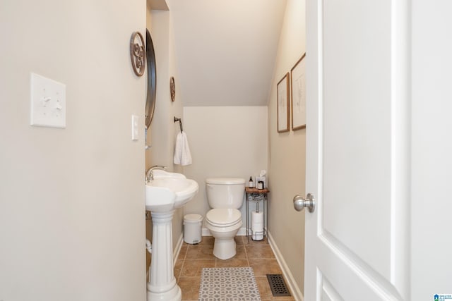 2616 Chimney Hills Cir, Vestavia Hills, AL 35226 - half bath with toilet, tile patterned flooring, vaulted ceiling, baseboards, and a sink