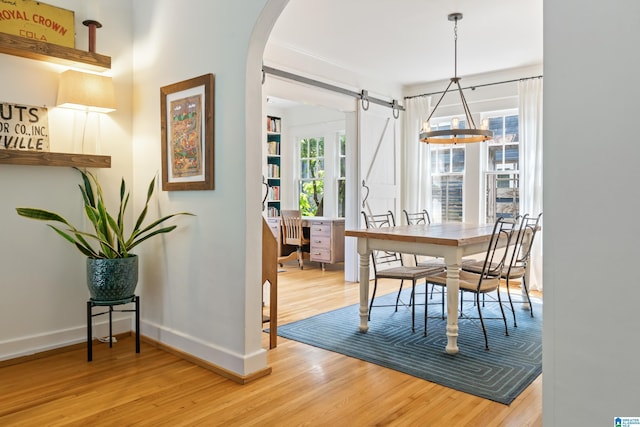 dining area with wood finished floors, baseboards, and plenty of natural light