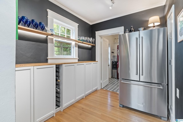 kitchen with freestanding refrigerator, wood counters, open shelves, light wood-type flooring, and ornamental molding