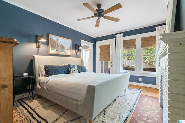 bedroom with a ceiling fan, crown molding, and baseboards