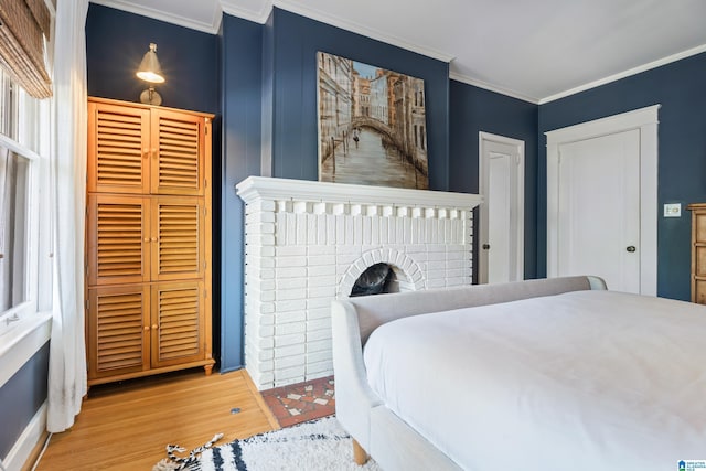 bedroom with ornamental molding and wood finished floors