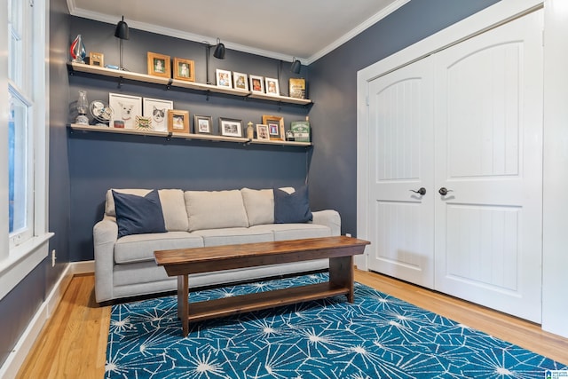 sitting room featuring wood finished floors and crown molding
