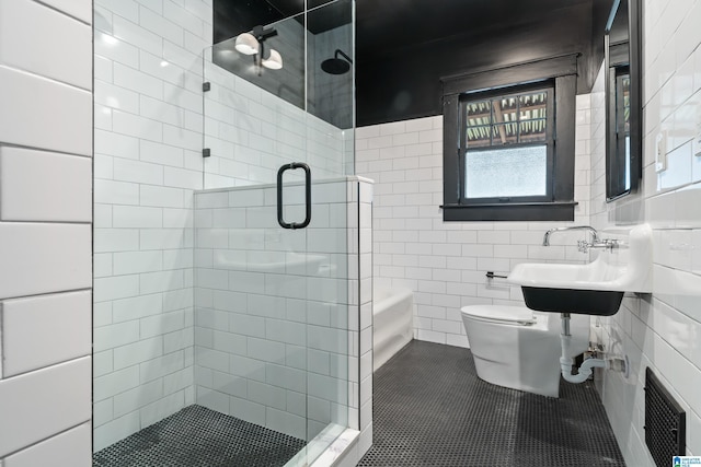 bathroom featuring a stall shower, toilet, and tile walls
