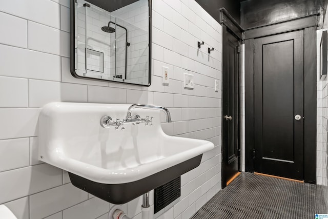 bathroom with tile walls and a sink