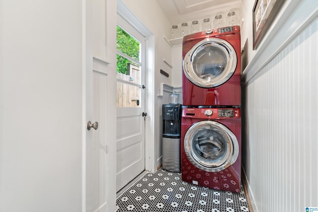 clothes washing area featuring estacked washer and dryer
