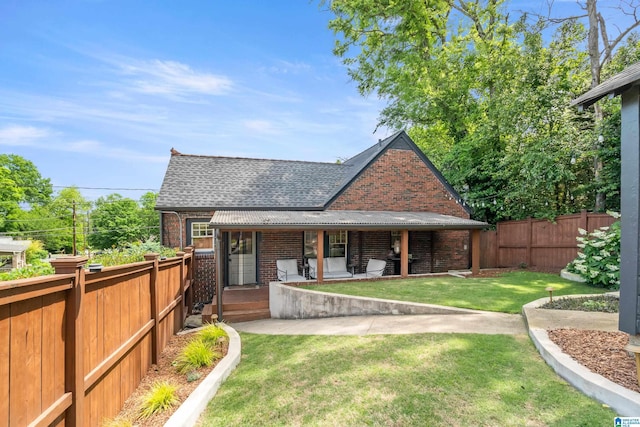 rear view of house with brick siding, a shingled roof, and a porch