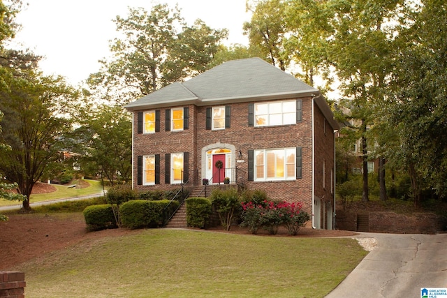 728 Kendall Dr, Vestavia Hills, AL 35226 - view of front of house with a front lawn, concrete driveway, a garage, and brick siding