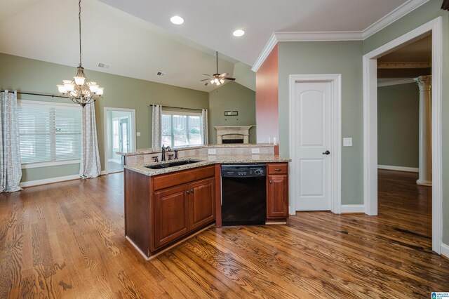 kitchen featuring black dishwasher, a sink, a ceiling fan, a fireplace, and brown cabinets