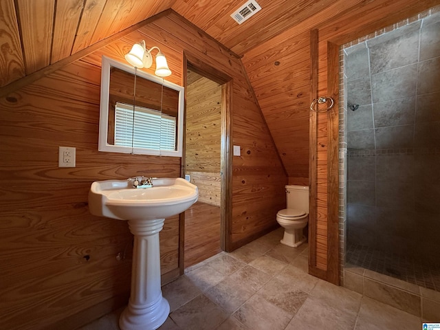 full bath with lofted ceiling, wooden walls, wood ceiling, toilet, and tiled shower