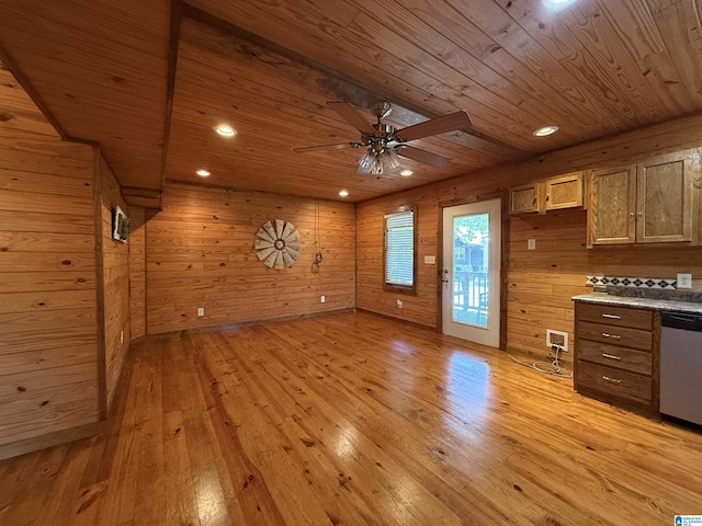 interior space featuring wooden ceiling, light wood-style flooring, a ceiling fan, and wooden walls