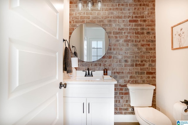 0571 Preserve Pkwy, Hoover, AL 35226 - half bathroom featuring vanity, toilet, and brick wall