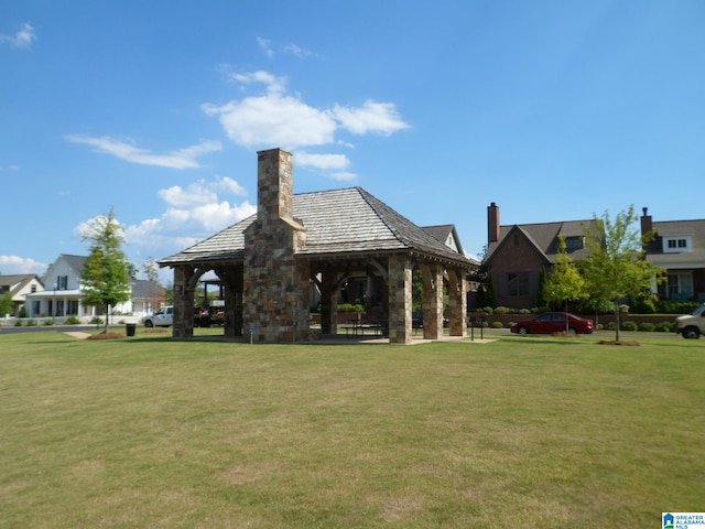 0571 Preserve Pkwy, Hoover, AL 35226 - back of house featuring a gazebo, a yard, a chimney, and stone siding