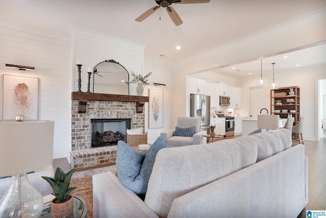 0571 Preserve Pkwy, Hoover, AL 35226 - living area with light wood-type flooring, a ceiling fan, a brick fireplace, crown molding, and baseboards