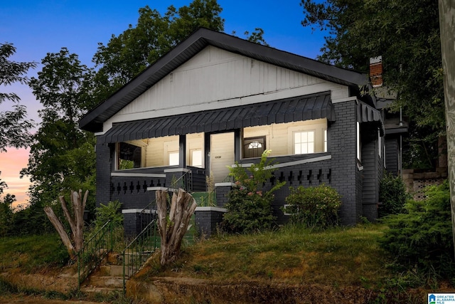 408 5th Pl, Birmingham, AL 35214 - bungalow-style home featuring brick siding, a chimney, and board and batten siding