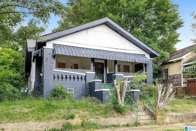 408 5th Pl, Birmingham, AL 35214 - bungalow featuring covered porch, brick siding, and board and batten siding