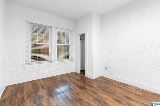 408 5th Pl, Birmingham, AL 35214 - unfurnished room with a textured wall, wood finished floors, baseboards, and a textured ceiling