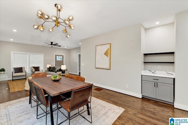 2624 29th St, Birmingham, AL 35208 - dining area with wood finished floors, a chandelier, baseboards, recessed lighting, and ceiling fan