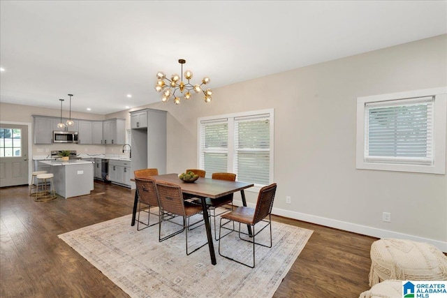 2624 29th St, Birmingham, AL 35208 - dining area featuring dark wood finished floors, a chandelier, baseboards, and recessed lighting