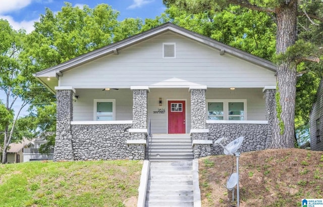 2624 29th St, Birmingham, AL 35208 - bungalow-style house featuring a porch, stone siding, and stairs