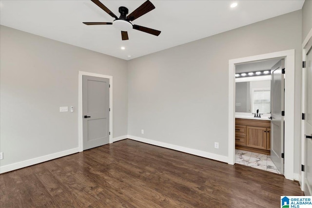 2624 29th St, Birmingham, AL 35208 - unfurnished bedroom with wood finished floors, baseboards, recessed lighting, a sink, and ensuite bathroom