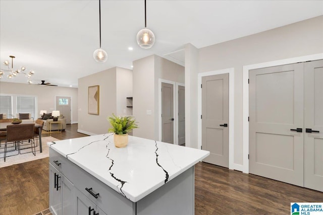 2624 29th St, Birmingham, AL 35208 - kitchen with hanging light fixtures, dark wood-style floors, open floor plan, a chandelier, and recessed lighting