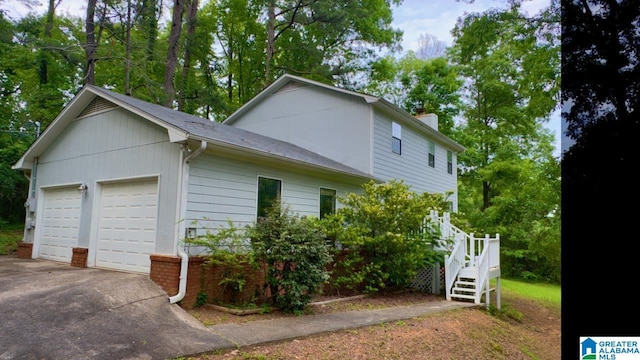 116 Pine Rock Ln, Hoover, AL 35226 - view of home's exterior with a chimney, concrete driveway, a shingled roof, an attached garage, and stairway