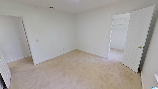 116 Pine Rock Ln, Hoover, AL 35226 - unfurnished bedroom with light carpet, a walk in closet, a closet, ornamental molding, and baseboards