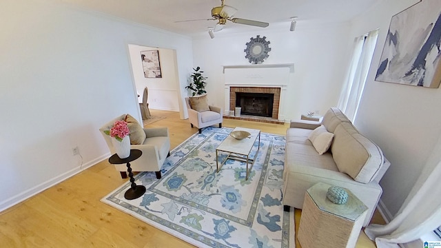 116 Pine Rock Ln, Hoover, AL 35226 - living room with a ceiling fan, baseboards, a brick fireplace, ornamental molding, and wood finished floors
