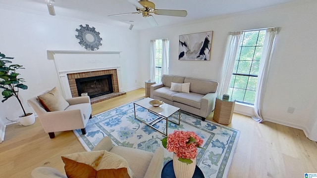 116 Pine Rock Ln, Hoover, AL 35226 - living room featuring healthy amount of natural light, wood finished floors, a fireplace, a ceiling fan, and crown molding
