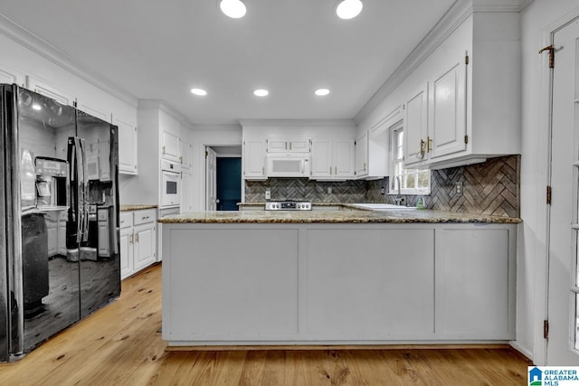 2247 Mill Run Cir, Hoover, AL 35226 - kitchen with white appliances, a sink, white cabinetry, a peninsula, and backsplash