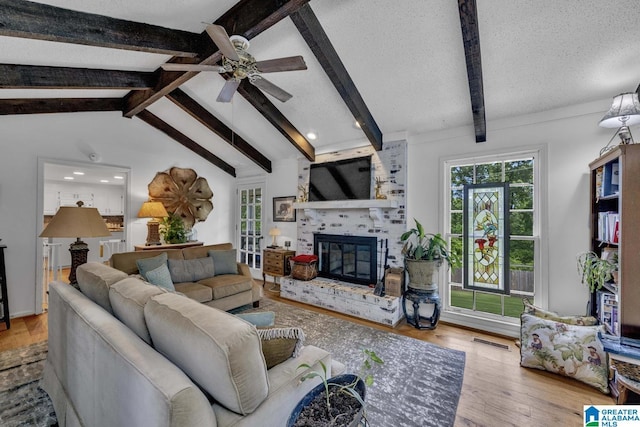 2247 Mill Run Cir, Hoover, AL 35226 - living area with plenty of natural light, a brick fireplace, ceiling fan, wood finished floors, and a textured ceiling