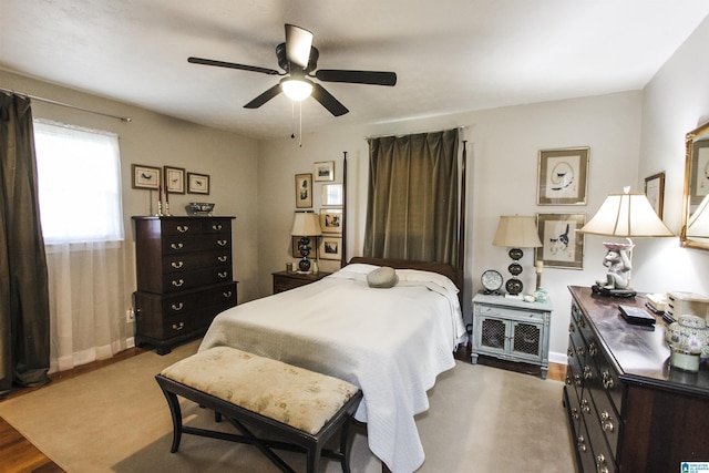 bedroom featuring baseboards, ceiling fan, and wood finished floors
