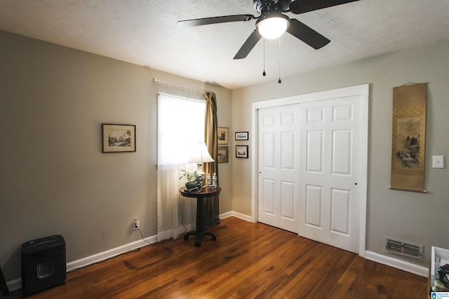foyer entrance featuring baseboards, wood finished floors, and ceiling fan