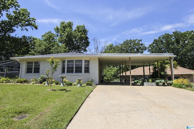 view of front of home with concrete driveway, brick siding, and a carport