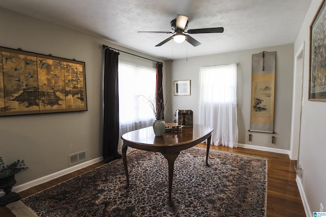 office area with wood finished floors, a ceiling fan, and baseboards