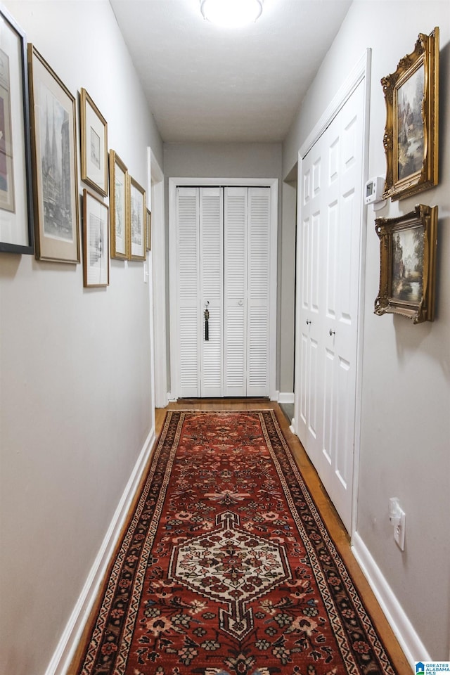 corridor featuring baseboards