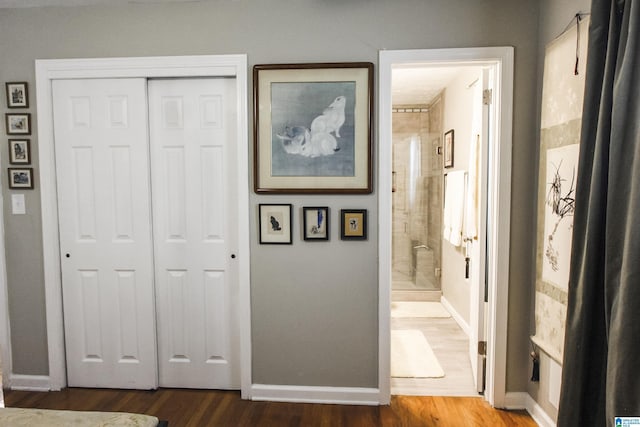 hall with wood finished floors and baseboards