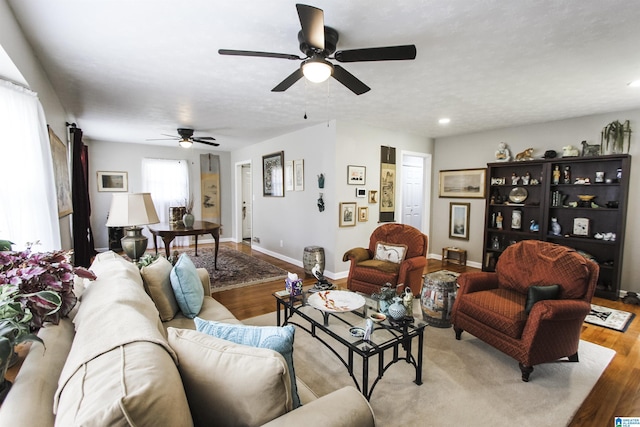 living room with a ceiling fan, wood finished floors, baseboards, and recessed lighting