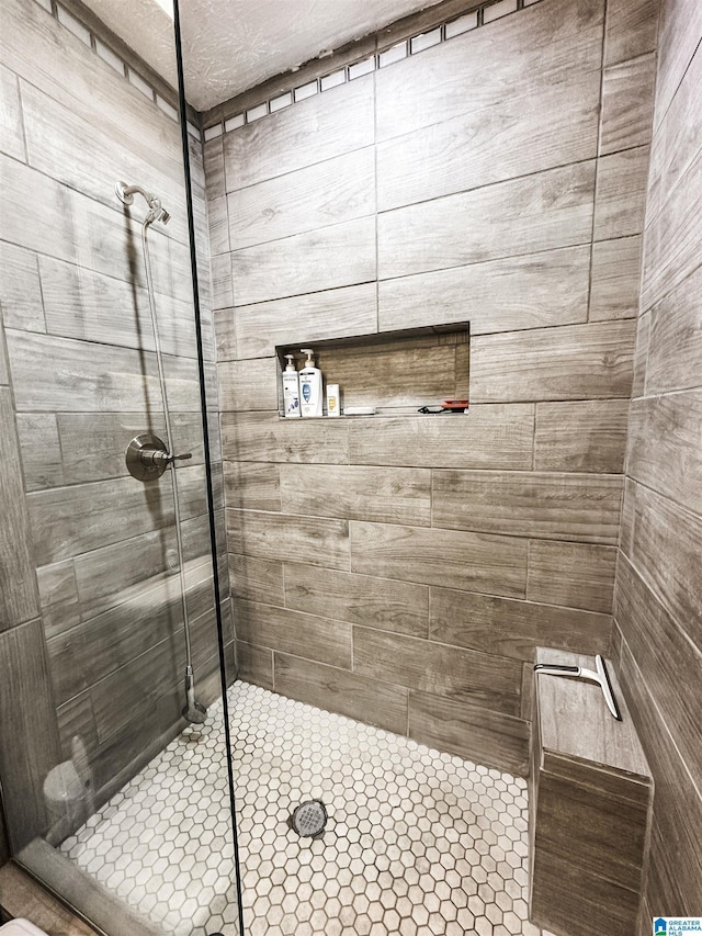 bathroom with tiled shower