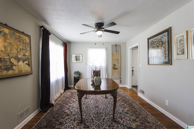 office with ceiling fan, dark wood-type flooring, and baseboards