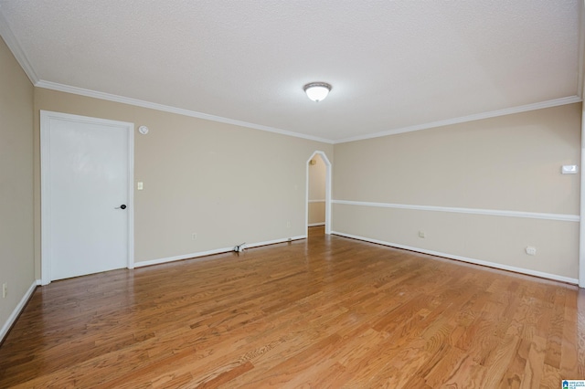 320 Cambo Ln, Hoover, AL 35244 - empty room featuring wood finished floors, crown molding, baseboards, and arched walkways