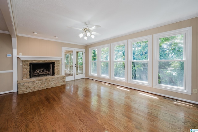 320 Cambo Ln, Hoover, AL 35244 - unfurnished living room featuring crown molding, a ceiling fan, wood finished floors, french doors, and a stone fireplace