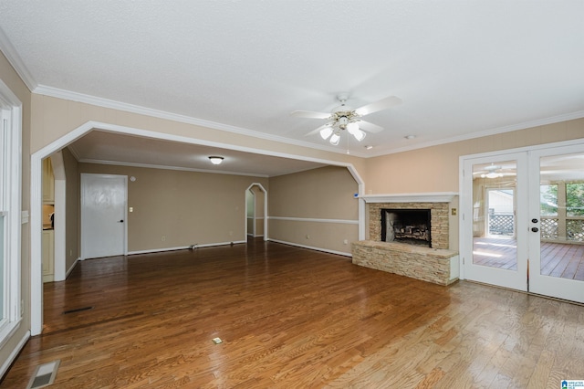 320 Cambo Ln, Hoover, AL 35244 - unfurnished living room featuring a ceiling fan, french doors, wood finished floors, ornamental molding, and a stone fireplace