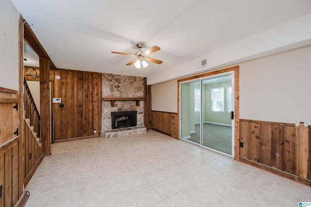 320 Cambo Ln, Hoover, AL 35244 - unfurnished living room featuring wooden walls, ceiling fan, a wainscoted wall, a fireplace, and stairs
