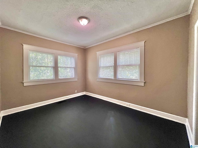 spare room with crown molding, a textured ceiling, and baseboards
