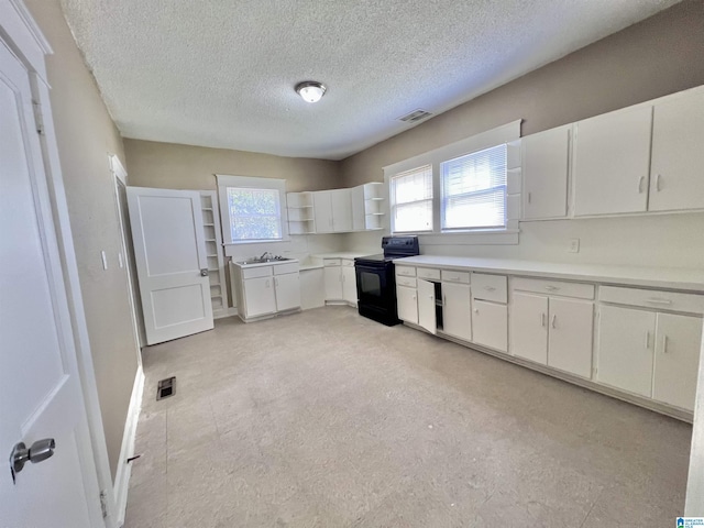 kitchen with black electric range, open shelves, a sink, white cabinetry, and light countertops