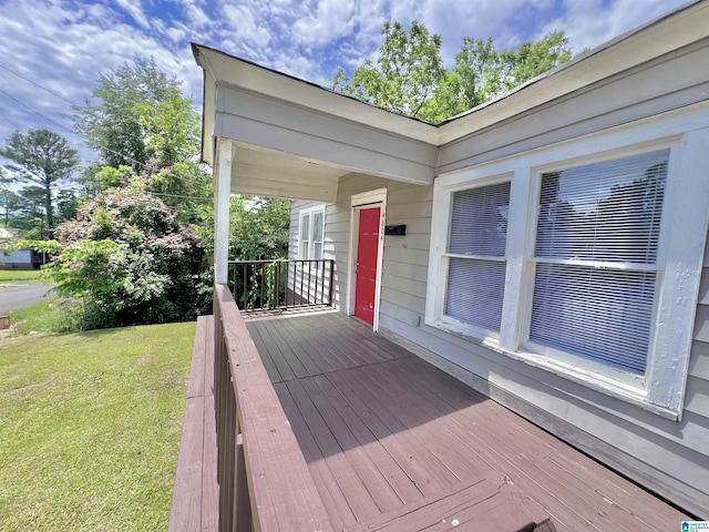 wooden deck with a yard and covered porch